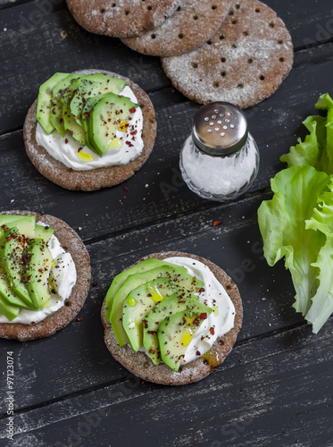 Healthy avocado sandwiches, on a dark wooden surface. Healthy breakfast or snack