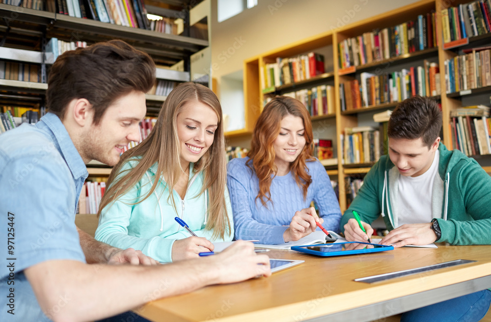 happy students with tablet pc in library happy students with tablet pc in library
