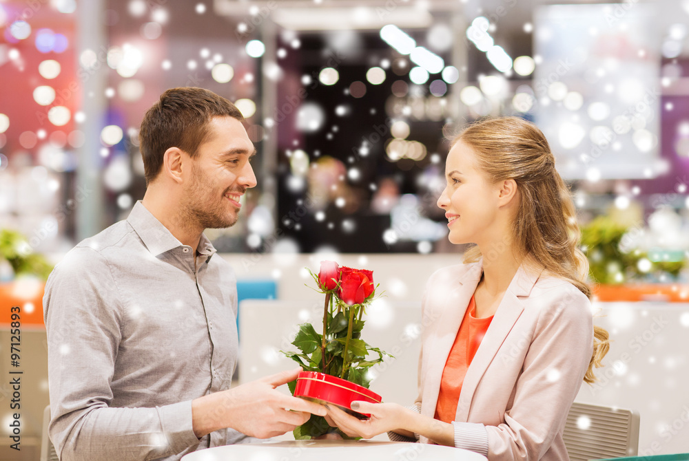 happy couple with present and flowers in mall happy couple with present and flowers in mall