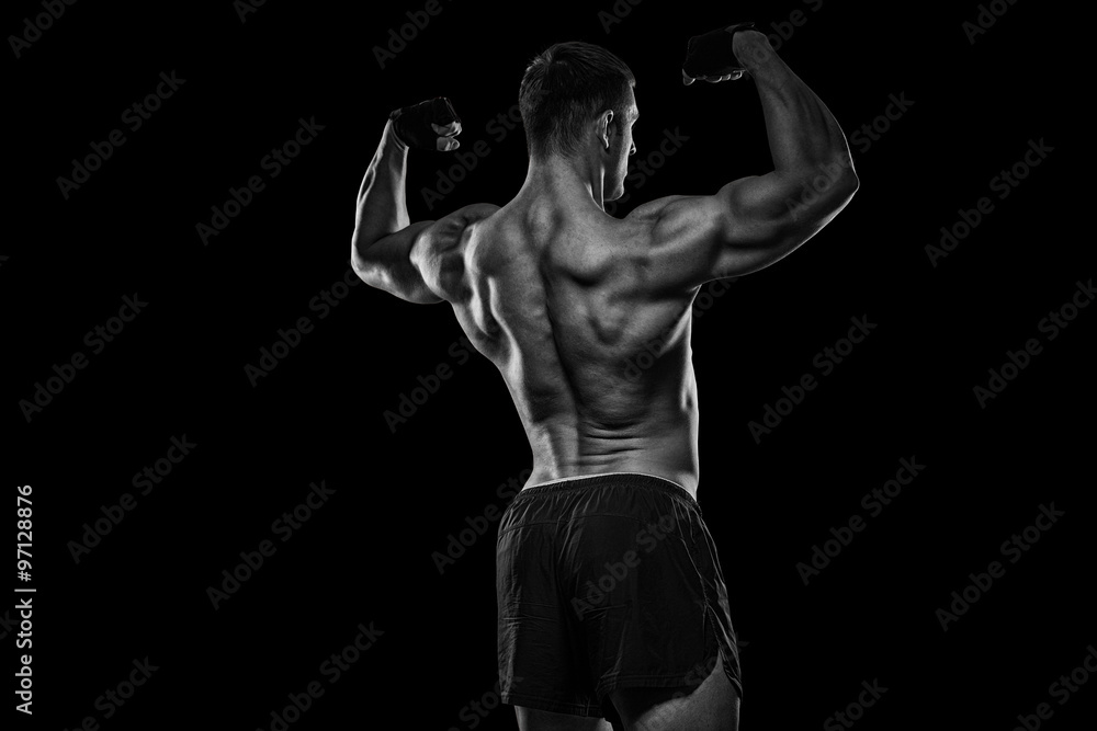 Naklejka premium Rear view of healthy muscular young man with his arms stretched