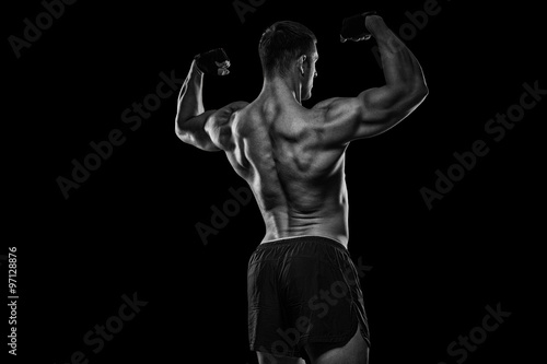 Rear view of healthy muscular young man with his arms stretched