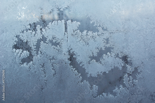 Frosty pattern on the frozen window. © alexsid