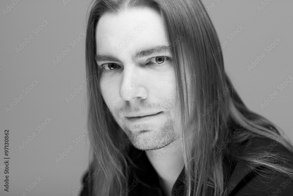 Young attractive man with long hair studio portrait Young attractive man with long hair studio portrait