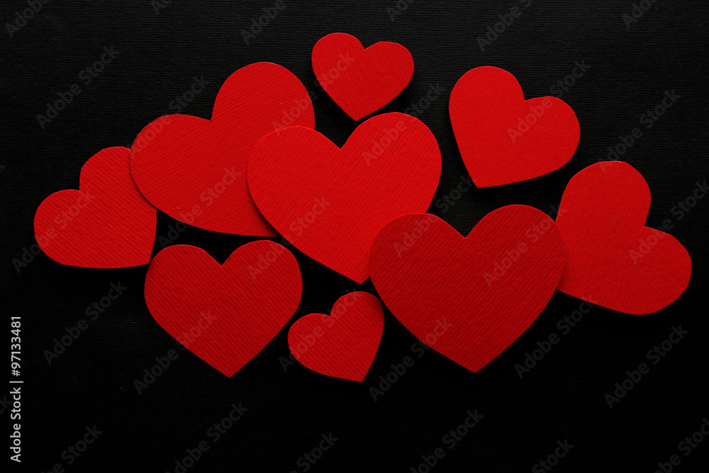 Red paper hearts on  black background