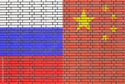 Russia and China flags on a wall