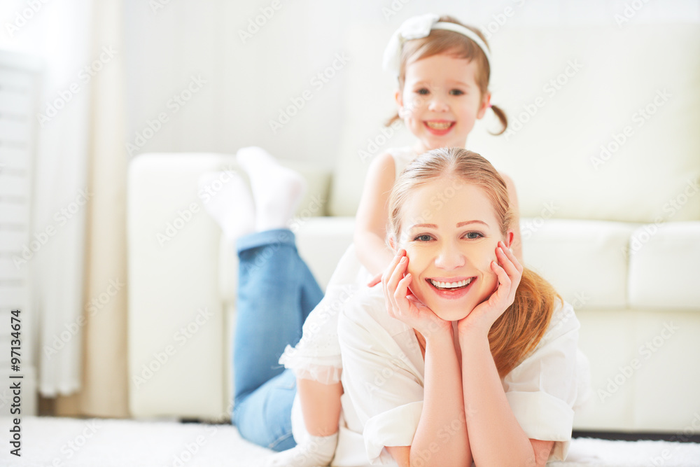 Happy loving family. mother and child playing lying on the floor Happy loving family. mother and child playing lying on the floor