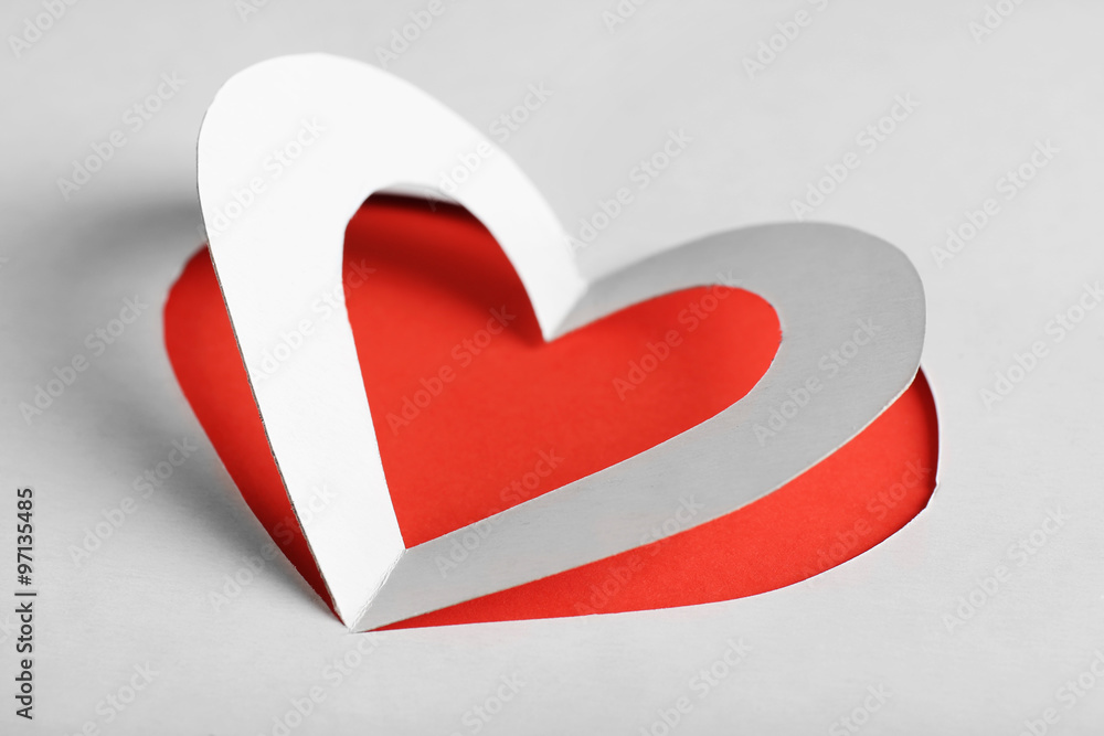 Cut out white paper heart on red background Cut out white paper heart on red background