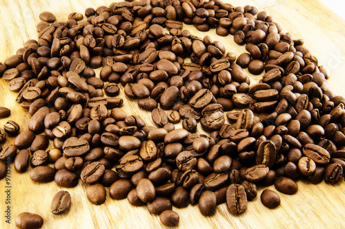 Coffee beans on vintage wooden board