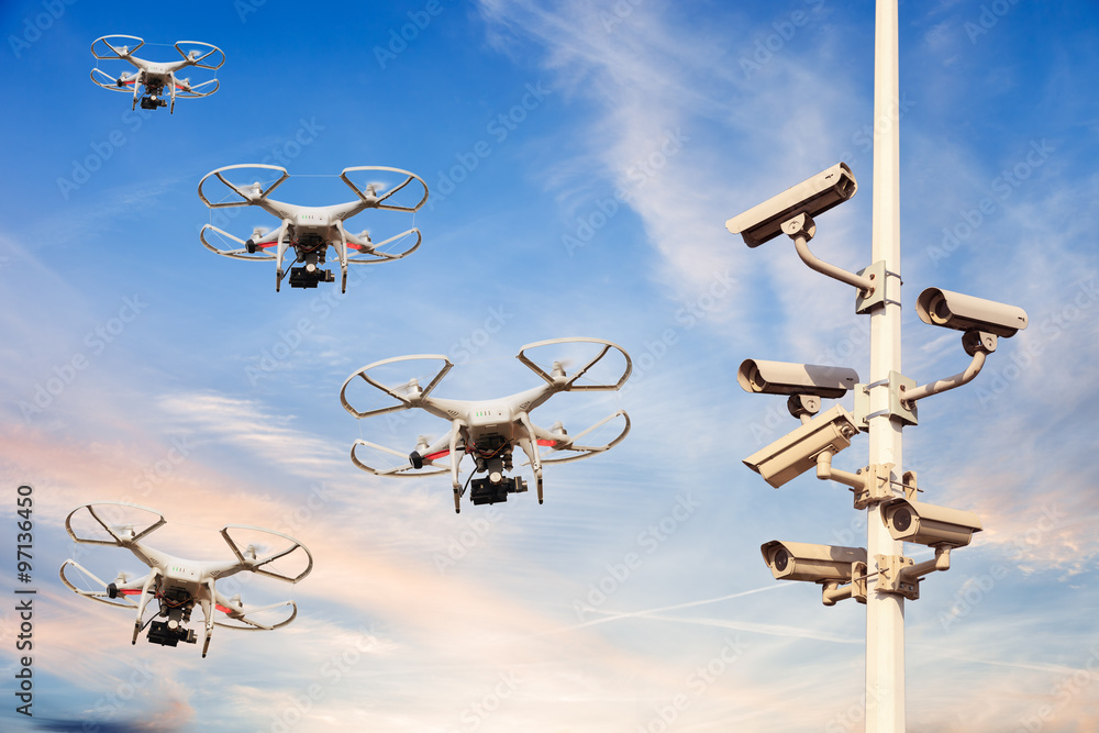 Many drones flying against the blue sky.