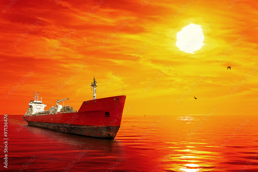 Silhouette of the tanker ship on red sunrise.