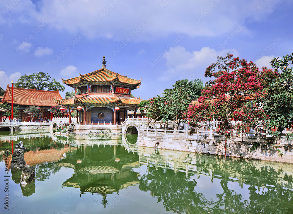 Pavilion mirrored in green pond, Yuantong Temple, Kunming, Yunnan Province, China.