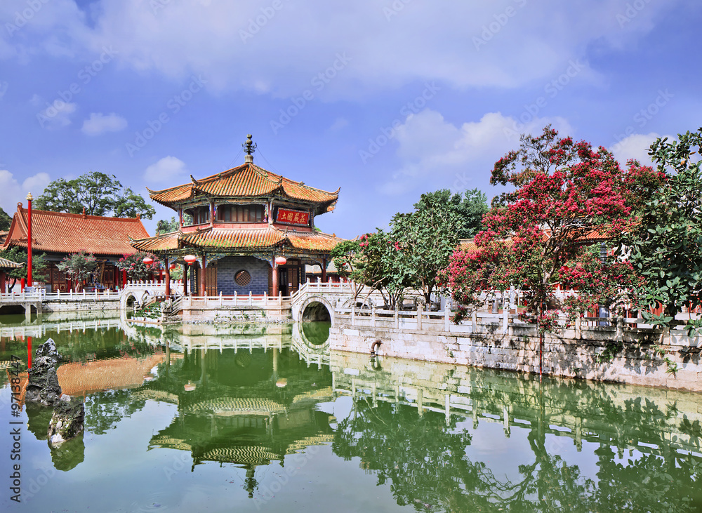 Pavilion mirrored in green pond, Yuantong Temple, Kunming, Yunnan Province, China. Pavilion mirrored in green pond, Yuantong Temple, Kunming, Yunnan Province, China.