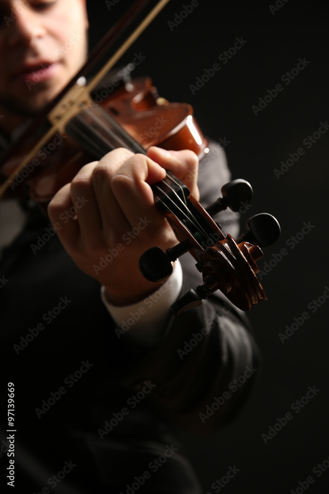 Musician play violin on black background, close up Musician play violin on black background, close up