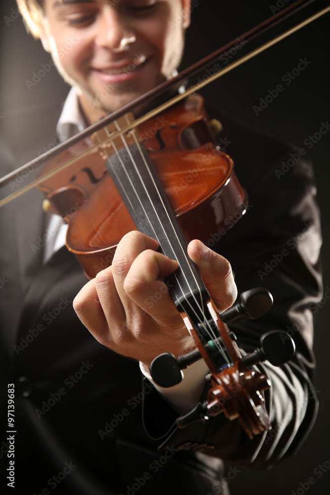 Violinist's performance on black background, close up Violinist's performance on black background, close up