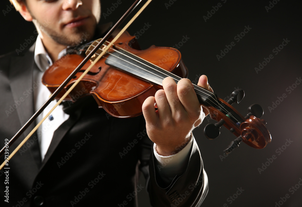 Violinist's performance on black background, close up Violinist's performance on black background, close up