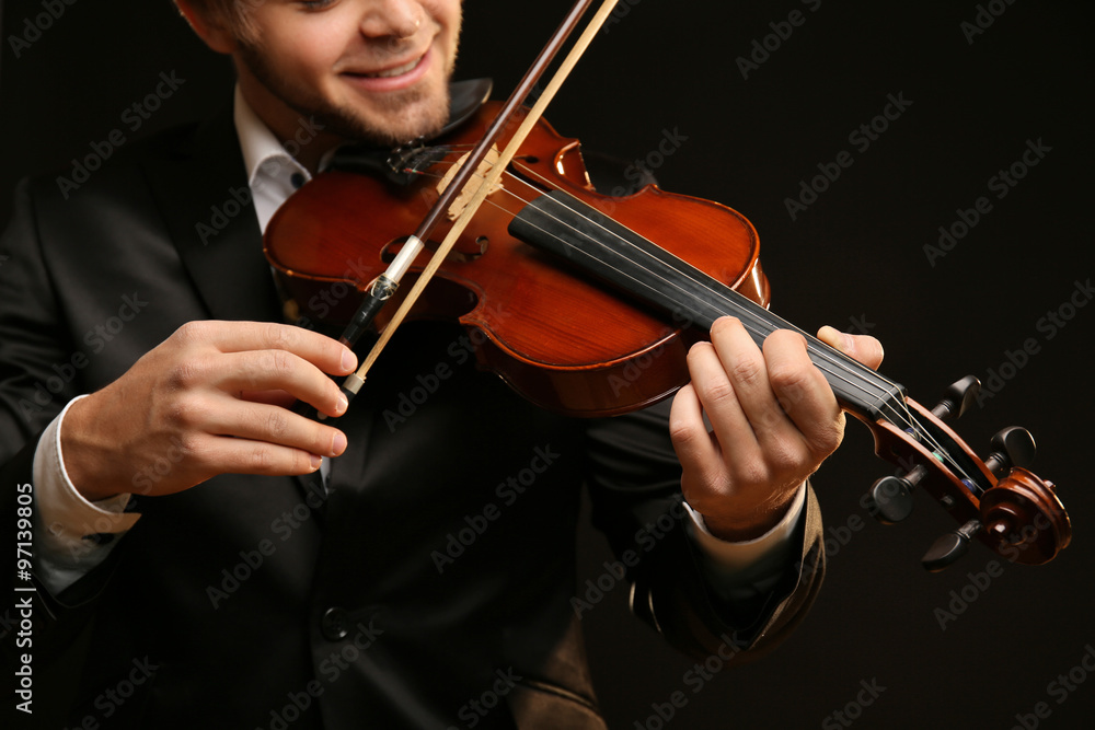 Musician plays violin on black background, close up Musician plays violin on black background, close up