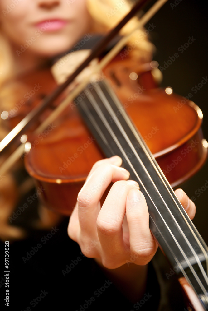Musician plays violin on black background, close up Musician plays violin on black background, close up
