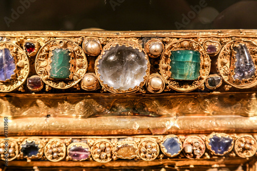 Antique gold jewelry with green and transparent stones. © photographyttl