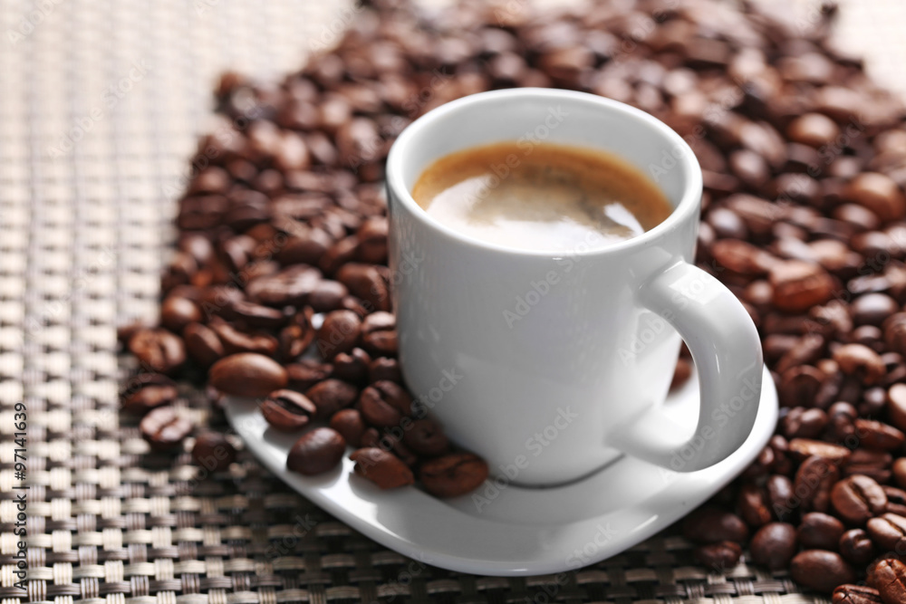 Cup of coffee and coffee grains on dark background Cup of coffee and coffee grains on dark background