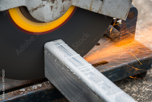 close up cutting a square metal and steel with compound mitre