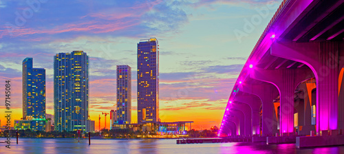 Miami Florida at sunset, colorful skyline of illuminated buildings and Macarthur causeway bridge © FotoMak