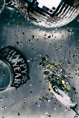 NYE: Disco Metal Background With Spilled Confetti From Glass