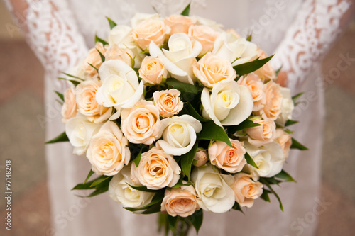 Beautiful wedding bouquet in hands of the bride