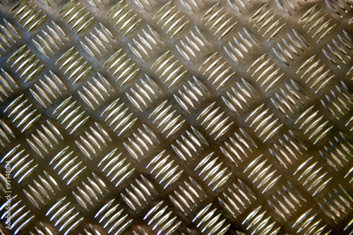 Metallic plate with a grid imposed pattern for gripping photo