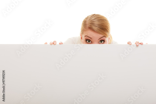 Businesswoman hiding behind blank copy space banner