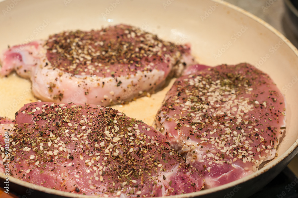Cooking meat with spice in a frying pan. Selective focus Cooking meat with spice in a frying pan. Selective focus