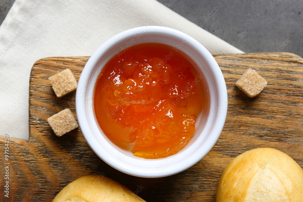 Tasty jam in the jar and bowl, crackers and fresh buns close-up Tasty jam in the jar and bowl, crackers and fresh buns close-up