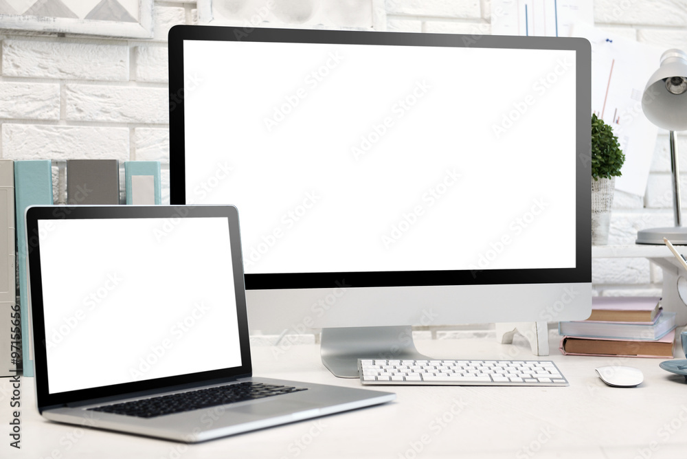 Workplace with computer and laptop on the table