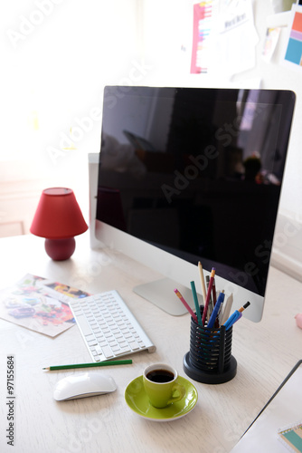 Modern computer on the table in decorated room