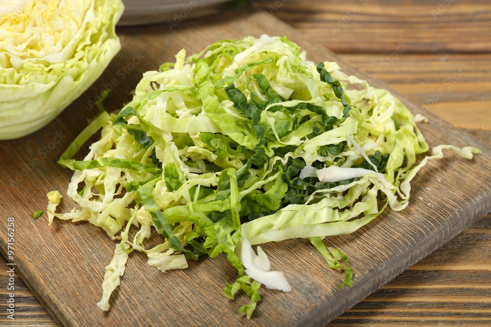 Cut savoy cabbage on wooden cutting board closeup Cut savoy cabbage on wooden cutting board closeup