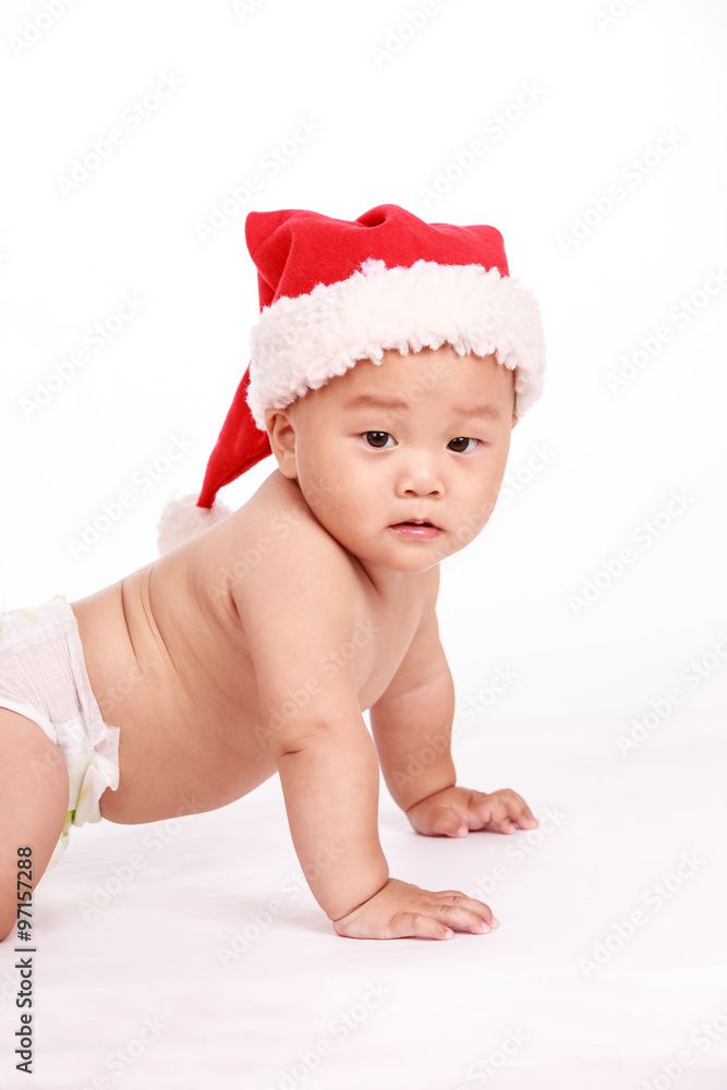 cute Oriental baby boy wearing christmas cap cute Oriental baby boy wearing christmas cap