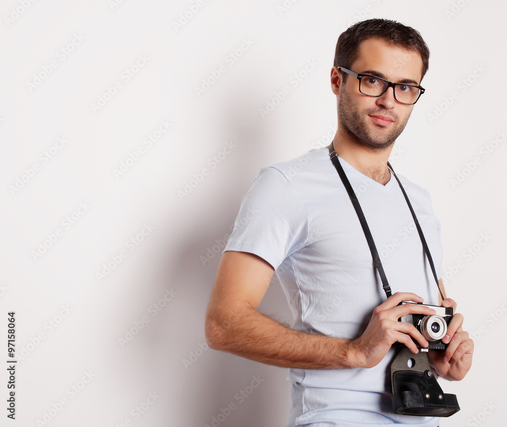 young man with a retro camera young man with a retro camera