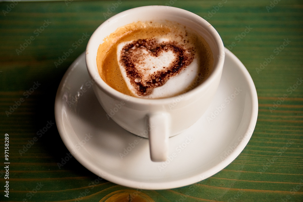 Cup of Coffee with Heart Inside the Cup on Green Wooden Background Cup of Coffee with Heart Inside the Cup on Green Wooden Background