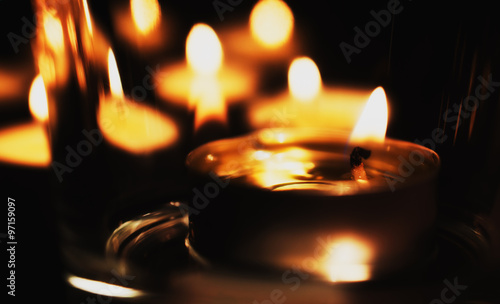 tea candles on a black background