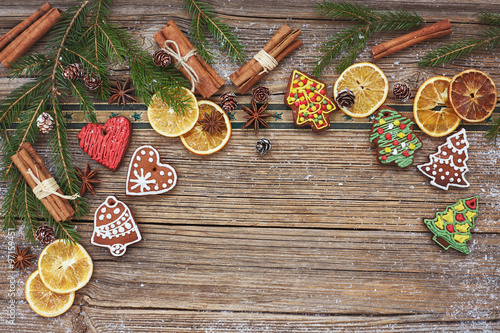  Christmas wooden background, Christmas tree, homemade gingerbread cookies, cinnamon sticks. Toned, soft focus, copy space