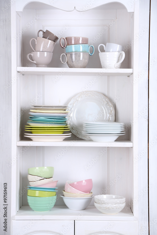 Different clean dishes on wooden shelves Different clean dishes on wooden shelves