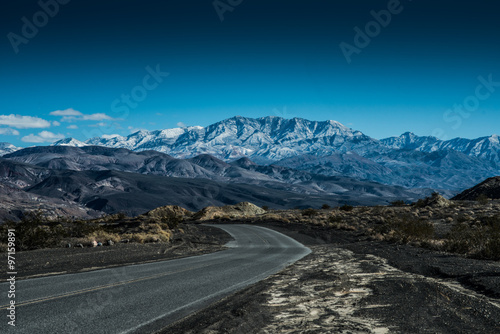 Road Leading to a Snowy Peak in Death Valley National Park photo