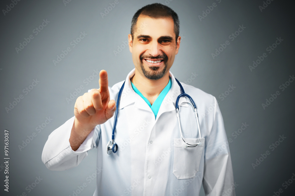 Portrait of a doctor with stethoscope on grey background Portrait of a doctor with stethoscope on grey background