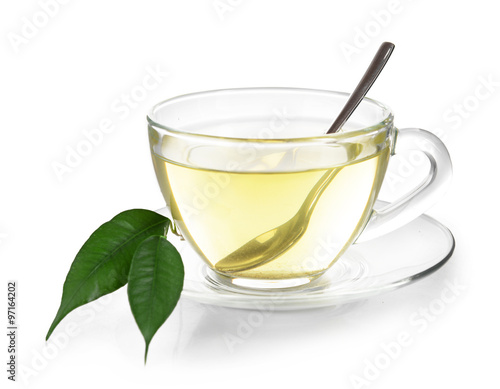 Glass cup of tea with green leaves isolated on white background