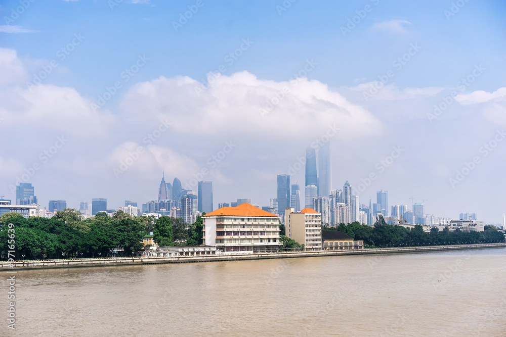 GUANGZHOU, CHINA - Oct.7: Day view of buildings by the Pearl River. The modern buildings on both sides of the Pearl River make it a beautiful landscape of the city. GUANGZHOU, CHINA - Oct.7: Day view of buildings by the Pearl River. The modern buildings on both sides of the Pearl River make it a beautiful landscape of the city.