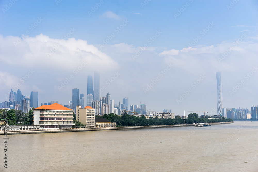 GUANGZHOU, CHINA - Oct.7: Day view of buildings by the Pearl River. The modern buildings on both sides of the Pearl River make it a beautiful landscape of the city. GUANGZHOU, CHINA - Oct.7: Day view of buildings by the Pearl River. The modern buildings on both sides of the Pearl River make it a beautiful landscape of the city.