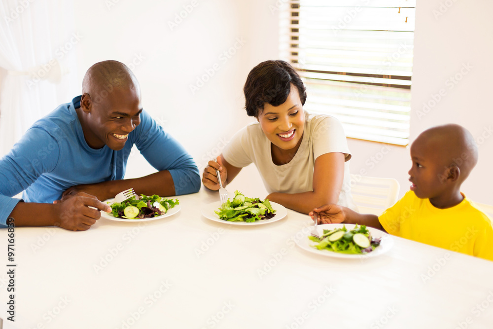african american family eating meal together