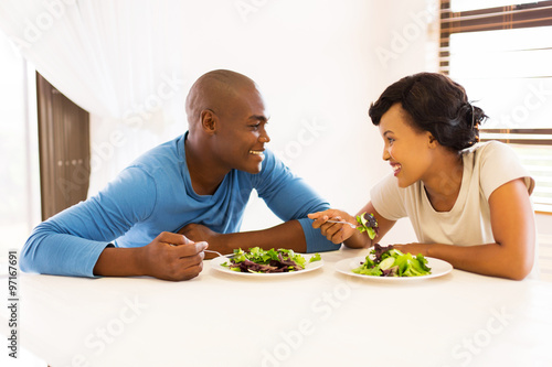 young african couple eating dinner together