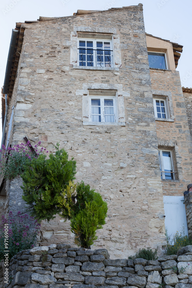 Ancient building with blue shutters in Provence, France