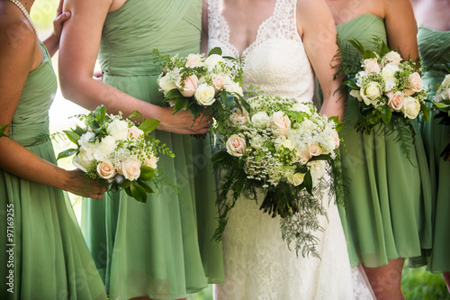 Bridesmaids and brides with beautiful green, pink and white rose photo