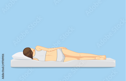 Spine of woman sleeping on white mattress.